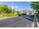View of community gate lined by manicured foliage and lush green trees at 3079 Paseo Mountain Ave, Henderson, NV 89052
