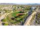 Community park with lush baseball field, surrounded by homes and modern community building at 3079 Paseo Mountain Ave, Henderson, NV 89052
