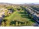 Aerial shot showcases soccer field and homes nestled in a lush landscape with mountain views at 3079 Paseo Mountain Ave, Henderson, NV 89052