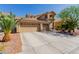 Exterior showcasing the home's three-car garage, attractive landscaping, and curb appeal at 3079 Paseo Mountain Ave, Henderson, NV 89052