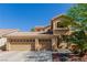 Exterior of a charming home boasting a three-car garage and meticulously maintained landscaping at 3079 Paseo Mountain Ave, Henderson, NV 89052