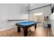 Upstairs game room featuring a pool table, and wall mounted television and arcade game at 3079 Paseo Mountain Ave, Henderson, NV 89052