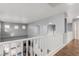 Bright hallway boasts hardwood floors, fresh paint, charming arches and a clean white railing at 3079 Paseo Mountain Ave, Henderson, NV 89052