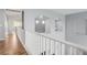 Upstairs hallway with wood floors and white railings, showcasing architectural details at 3079 Paseo Mountain Ave, Henderson, NV 89052