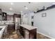 Modern kitchen with stainless appliances, island, and stylish hanging pendant lights at 3079 Paseo Mountain Ave, Henderson, NV 89052