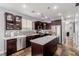 Well-lit kitchen with stainless steel appliances, an island, and dark cabinetry at 3079 Paseo Mountain Ave, Henderson, NV 89052