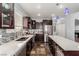 Modern kitchen with stainless steel appliances, dark wood cabinets, and light countertops at 3079 Paseo Mountain Ave, Henderson, NV 89052
