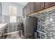 Well-equipped laundry room featuring modern washer and dryer, upper cabinets and designer backsplash at 3079 Paseo Mountain Ave, Henderson, NV 89052