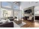 Open living room with large windows, a fireplace with stone surround, hardwood floors and neutral décor at 3079 Paseo Mountain Ave, Henderson, NV 89052
