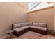 Cozy outdoor patio featuring a wicker sectional sofa, string lights, and tiled flooring at 3079 Paseo Mountain Ave, Henderson, NV 89052
