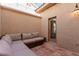 Relaxing outdoor patio space with wicker seating, string lights, and a door leading indoors at 3079 Paseo Mountain Ave, Henderson, NV 89052