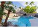 Backyard featuring a pool with attached spa, mature trees, and lounge chairs at 3079 Paseo Mountain Ave, Henderson, NV 89052