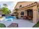 Back exterior showcasing a large pool with attached spa, lounge chairs, and covered dining area at 3079 Paseo Mountain Ave, Henderson, NV 89052