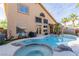 Back exterior showcasing a large pool with attached spa, well manicured plants, and lounging area at 3079 Paseo Mountain Ave, Henderson, NV 89052
