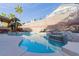 Beautiful pool and spa featuring rock accents, lounge chairs, and desert landscaping at 3079 Paseo Mountain Ave, Henderson, NV 89052