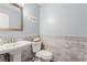Elegant powder room boasts marble tile, decorative trim, and stylish vanity at 3079 Paseo Mountain Ave, Henderson, NV 89052