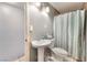 Bathroom featuring a pedestal sink, toilet, and shower with a curtain at 3112 Twining Ave, North Las Vegas, NV 89030