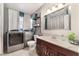 Bathroom with vanity, toilet, front loading washer and dryer, and storage shelves at 3112 Twining Ave, North Las Vegas, NV 89030