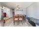 Neutral dining room with tile floors, ceiling fan, a dark wooden table and access to other rooms at 3112 Twining Ave, North Las Vegas, NV 89030