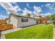 Back exterior view showing a well-manicured lawn and outdoor pergola at 325 Heather Dr, Henderson, NV 89002