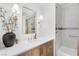 Elegant bathroom with wood vanity, marble countertop, and tiled shower at 325 Heather Dr, Henderson, NV 89002
