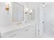 Bright bathroom featuring white vanity with gold fixtures, a decorative mirror, and access to the toilet at 325 Heather Dr, Henderson, NV 89002