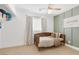 Stylish bedroom with a wooden bed, green accent wall, and ceiling fan at 325 Heather Dr, Henderson, NV 89002