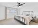 Comfortable bedroom with a metal frame bed, neutral bedding, a ceiling fan and lots of natural light at 325 Heather Dr, Henderson, NV 89002