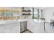 Bright kitchen featuring white countertops, an apron sink, stainless steel appliances and wood floating shelves at 325 Heather Dr, Henderson, NV 89002