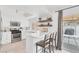 Bright kitchen with white cabinets, stainless steel appliances, breakfast bar and outdoor view at 325 Heather Dr, Henderson, NV 89002