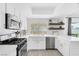 Modern kitchen featuring stainless steel appliances, white countertops, and a farmhouse sink at 325 Heather Dr, Henderson, NV 89002