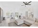 Bright living room featuring tile floors, neutral colors, an open floorplan, and views to the kitchen at 325 Heather Dr, Henderson, NV 89002