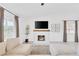 Bright living room featuring tile floors, neutral colors, a fireplace, and large windows at 325 Heather Dr, Henderson, NV 89002