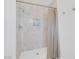Modern walk-in shower featuring white tile, a shower niche, and glass shower door at 325 Heather Dr, Henderson, NV 89002