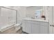 Bright bathroom featuring a glass shower, and a white vanity with a large mirror at 3762 Sonrisa Vista Ave, Henderson, NV 89044