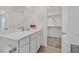 Bathroom featuring white cabinets, a white countertop and a walk in closet at 3762 Sonrisa Vista Ave, Henderson, NV 89044