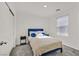 Bedroom with a blue headboard, carpeted floor, window and side tables with lamps at 3762 Sonrisa Vista Ave, Henderson, NV 89044