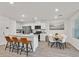 Bright eat-in kitchen features stainless appliances, white cabinetry, and three-seat island at 3762 Sonrisa Vista Ave, Henderson, NV 89044