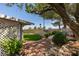 Lush backyard with mature trees, landscaping, and a cozy patio area at 4004 Nancy Margarite Ln, Las Vegas, NV 89130