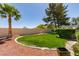 Spacious backyard with well-manicured lawn, mature landscaping, and privacy fencing at 4004 Nancy Margarite Ln, Las Vegas, NV 89130
