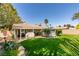 Expansive backyard with covered patio, lush lawn, and mature trees at 4004 Nancy Margarite Ln, Las Vegas, NV 89130