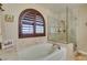 Luxurious bathroom featuring a soaking tub, a glass-enclosed shower, and stylish fixtures at 4004 Nancy Margarite Ln, Las Vegas, NV 89130