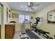 Spare bedroom set up as exercise room with treadmill, elliptical and bright yellow walls at 4004 Nancy Margarite Ln, Las Vegas, NV 89130