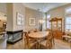 Elegant dining room featuring a fireplace, wood floors, and ample natural light from shuttered windows at 4004 Nancy Margarite Ln, Las Vegas, NV 89130