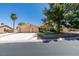 Single-story home featuring a two-car garage, palm tree, mature shade tree and manicured landscaping at 4004 Nancy Margarite Ln, Las Vegas, NV 89130