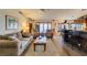 Open living room flows into the kitchen, boasting a ceiling fan, comfortable seating, and wood floors at 4004 Nancy Margarite Ln, Las Vegas, NV 89130