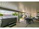 Covered patio area with a hot tub, seating, and views of the lush backyard at 4004 Nancy Margarite Ln, Las Vegas, NV 89130