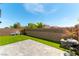 Landscaped backyard featuring artificial grass, BBQ, and block wall for privacy at 4517 Swimming Minnow Ave, Las Vegas, NV 89141