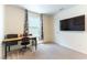 This bedroom features a window for natural light, a sleek desk, and a mounted TV at 4517 Swimming Minnow Ave, Las Vegas, NV 89141