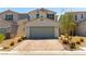 Charming two-story home featuring a two-car garage, landscaped yard, and inviting curb appeal at 4517 Swimming Minnow Ave, Las Vegas, NV 89141